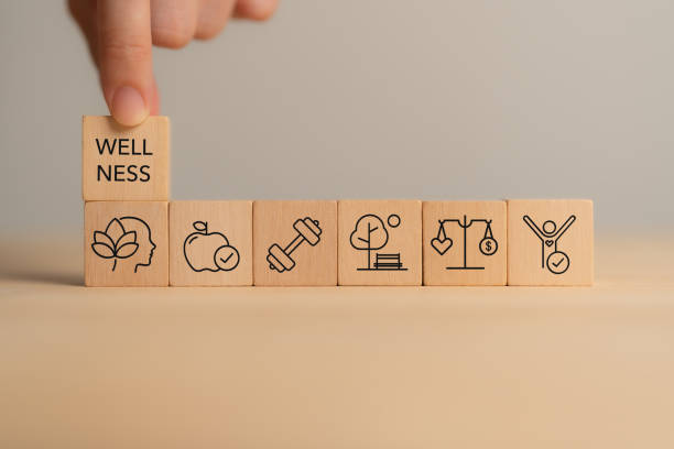 Holistic Wellness Concept. Wooden block with wellness icons, health care ,including mental well-being, fitness, nutrition, sleep, relationships and financial balance. Personal development and balance.
